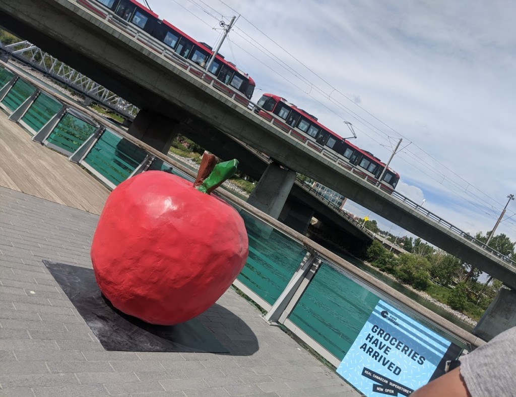 A large red apple sculpture sits in downtown Calgary.