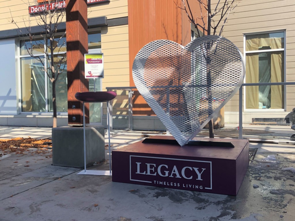 A photo of the Legacy Hearts sculpture in front of a building.