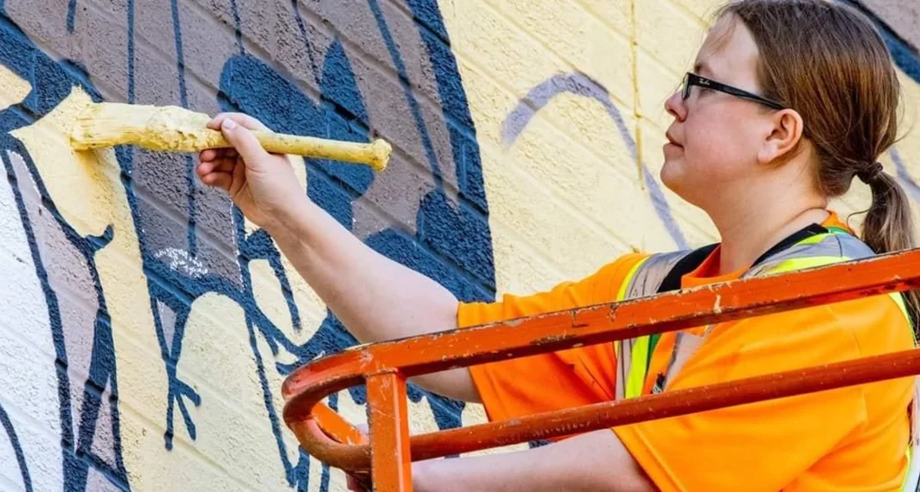 Jamie paints a mural.