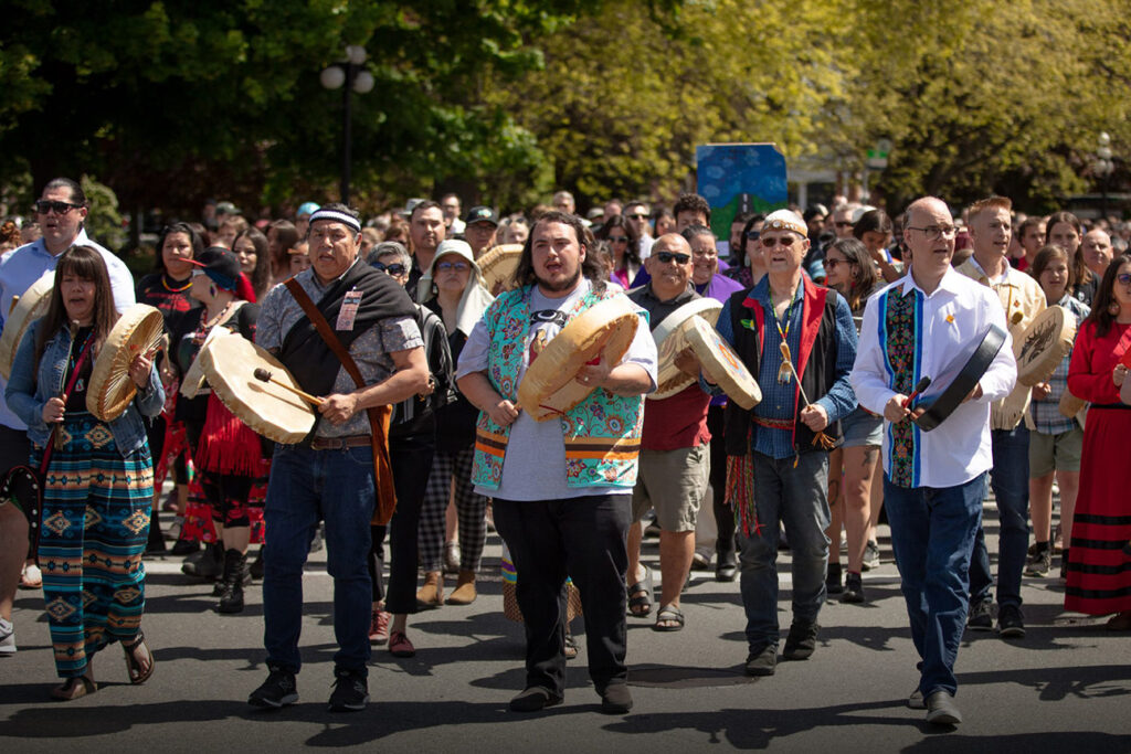 Indigenous leaders beat drums at the front of the Moose Hide Campaign's Walk to End Violence.